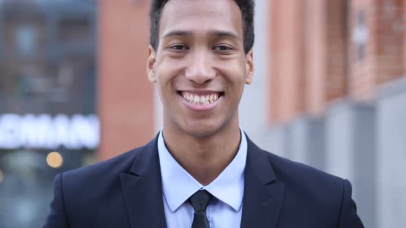 Portrait of Smiling African Businessman Looking at Camera