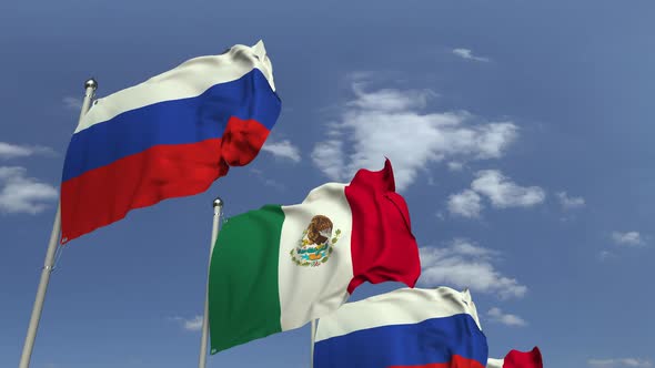 Waving Flags of Mexico and Russia on Sky Background alt