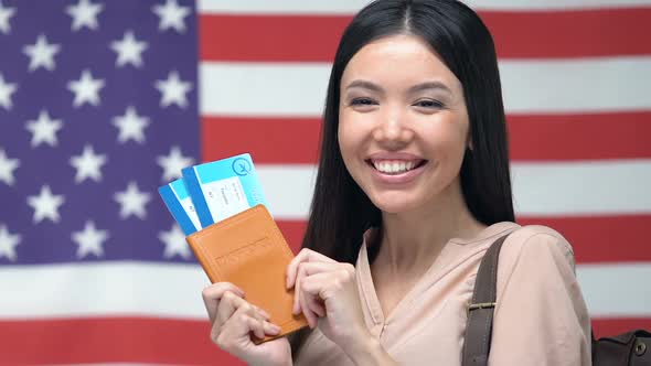 Happy Woman Holding Passport and Tickets, Travelling to the USA, Green Card