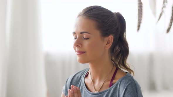 Woman Meditating at Yoga Studio