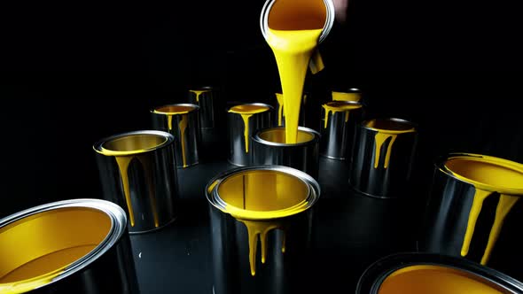 Yellow Paint Pouring. Paint Is Poured Into a Can