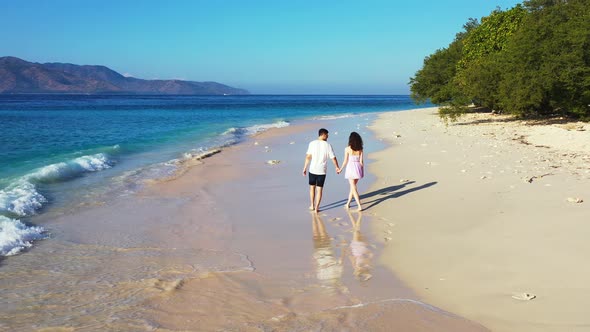 Young boy and girl on romantic honeymoon have fun on beach on paradise white sand 4K background