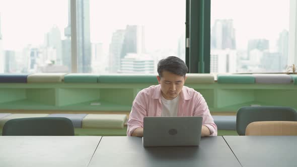 Concentrated young man freelancer looking at laptop screen,  Stressed guy chatting in social network