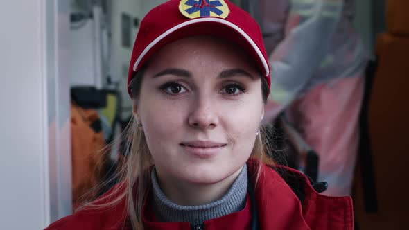 Young Female Paramedic Smiling During Work