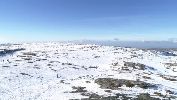 People Enjoying on Snow Mountain