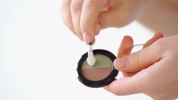 Female Hands Applying Eyeshadows on Palm Close Up