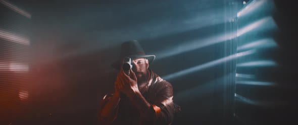 Man in smoke and lights of shutters and laser