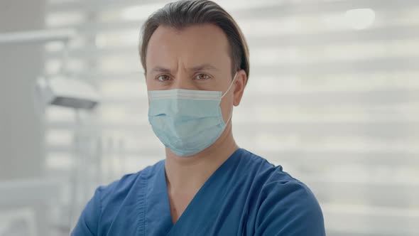 Young Doctor Standing In Dental Office