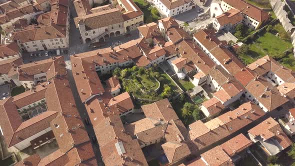 Top down aerial view of a small historic town Venzone in Northern Italy with red tiled roofs