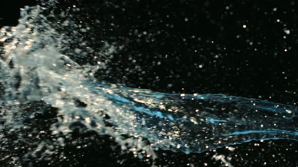 Slowmotion of big splash of water on black background.