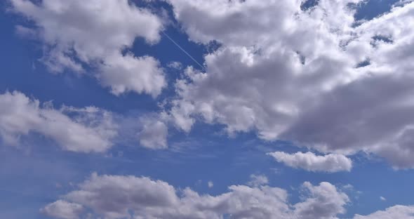 White Fluffy Cumulus Clouds Flying Blue Sky at Fast Moving Cloud