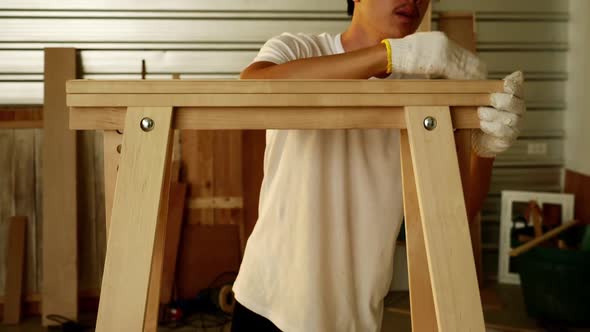 Woodwork and furniture making concept. Stylish craftsman working in his carpentry workshop