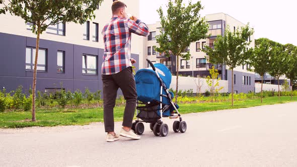 Father with Baby in Stroller and Coffee in City