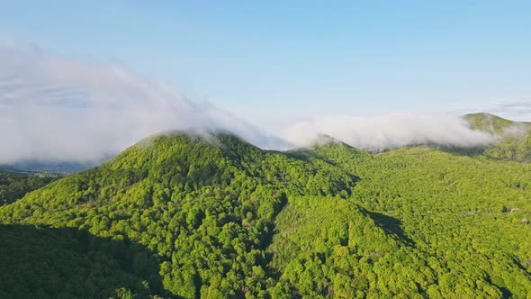 Aerial View Hyperlapse of Green Mountains Covered with Morning Clouds