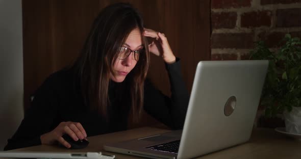 Woman Working at Night Using Laptop