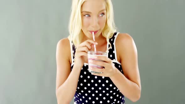 Beautiful woman drinking smoothie