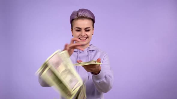 Young Person Gen Z Throwing Bunch Money on Camera Isolated on Purple