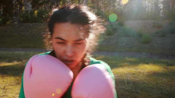 Determined women practicing boxing during obstacle course