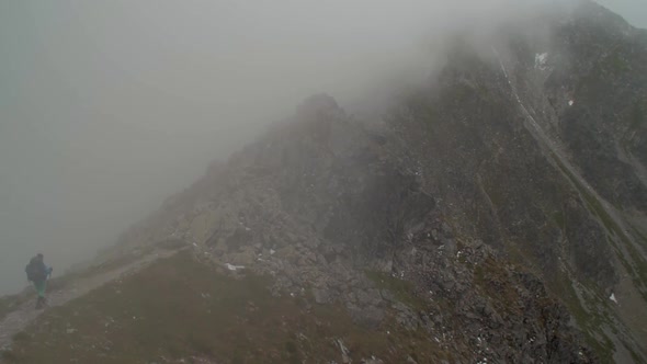 rocky alpine peaks, landscape of a slovakian tatra mountains, woman or female hiker hiking with back