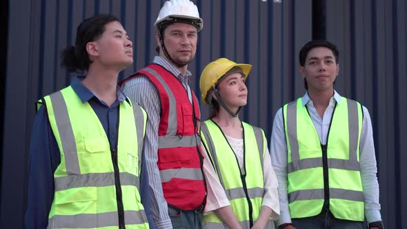 Cheerful factory worker and engineer at cargo containers, Dock workers team in a shipyard