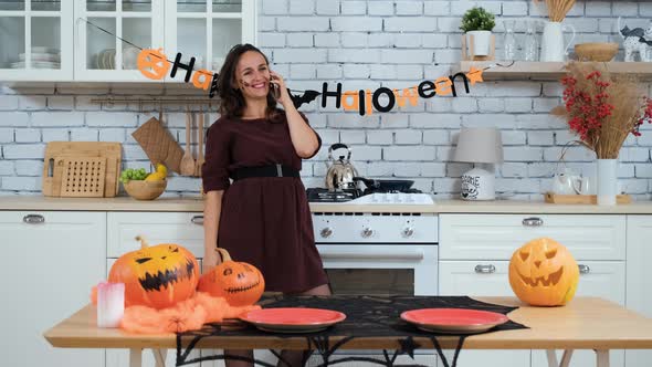 Woman Talking on Phone in Halloween at Home