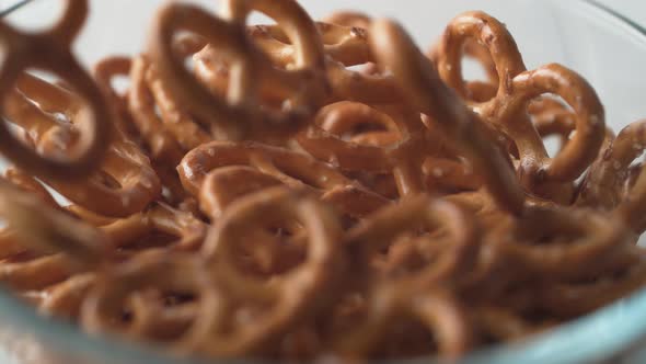 Pretzels falling into a bowl. Slow Motion.