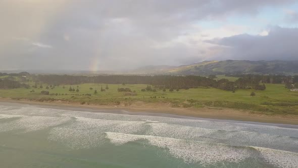 Rainbow and stormy clouds by the sea