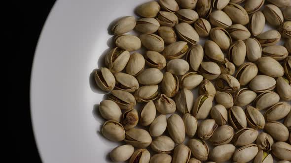 Cinematic, rotating shot of pistachios on a white surface - PISTACHIOS 003