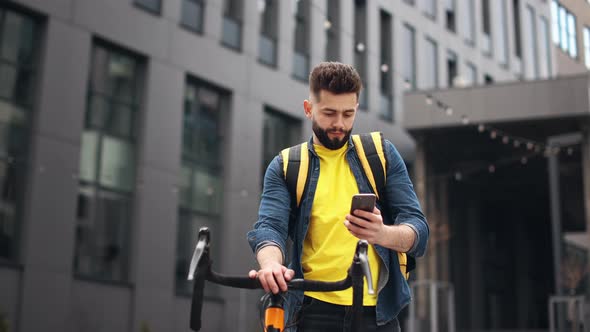 The Food Delivery Guy is Standing and Texting