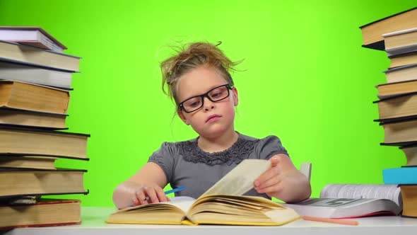 Girl Sitting and Leafing Through the Book. Green Screen. Slow Motion