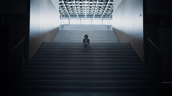 Lonely Schoolchild Sitting Alone on School Staircase Closeup