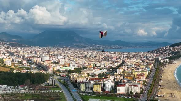 Aerial view 4 K parachute jumper flying over beautiful Alanya