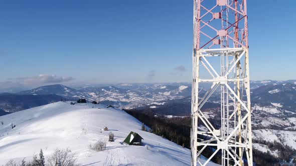 Flying Over Radio Communications Tower, Mountain Snow Covered Winter Landscape