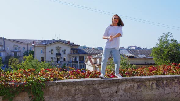 Girl Performing Modern Dances on Retaining Wall