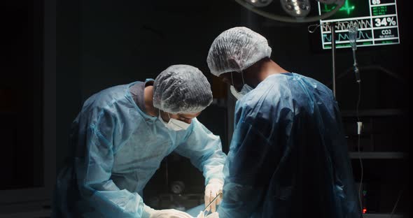 A Team of Surgeons Perform an Operation in a Bright Operating Room