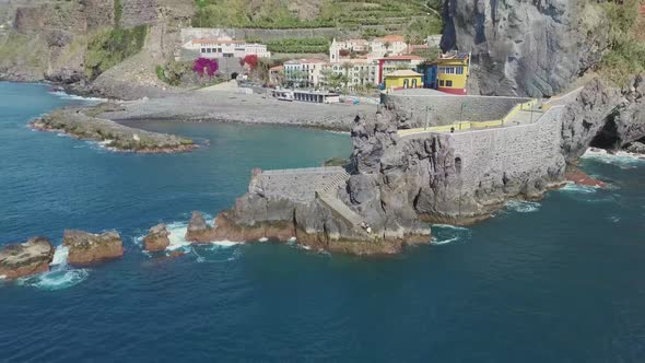 Idyllic town Ponta do Sol hidden between mountainous valley on Madeira shore