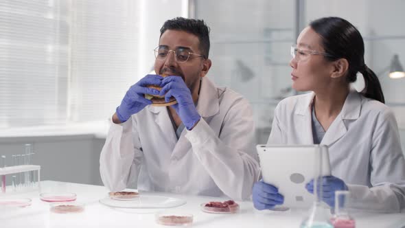 Man Trying Lab Burger With In Vitro Meat