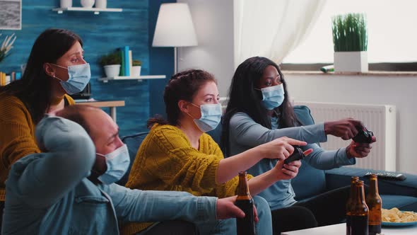 Friends with Masks Holding Controllers Playing Video Game