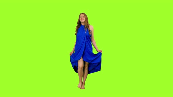 Cute Young Woman Walks in Blue Dress 