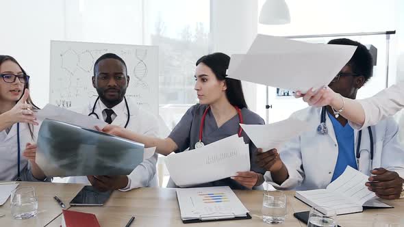 Team of Doctors Having a Meeting in Conference Room in the Modern Hospital