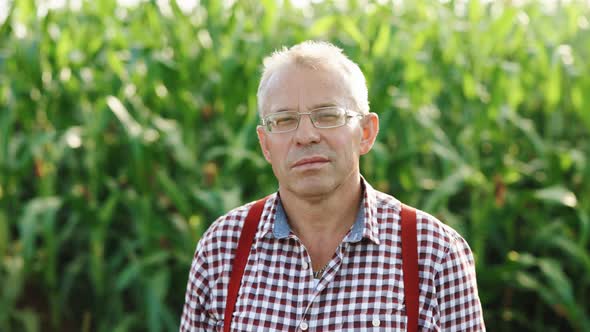 Farmer Crop Working Portrait Stands in the Field Resting During the Harvest