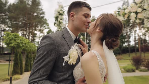 Newlyweds Caucasian Groom with Bride Walking Embracing Hugs in Park Wedding Couple