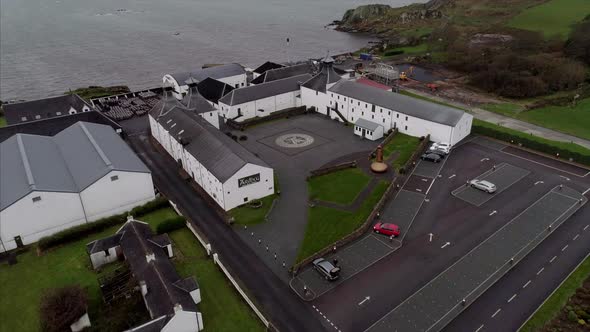 Aerial of a Distillery by the Rocky Shores of Loch Uigeadail in Islay