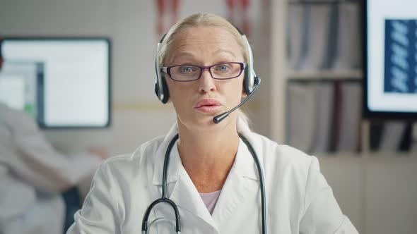 Senior Doctor Wearing Headset in Medical Consultation Call Center