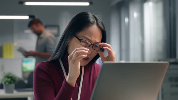 Close Up Portrait of Stressed Businesswoman Sitting in Office and Looking at Laptop Screen