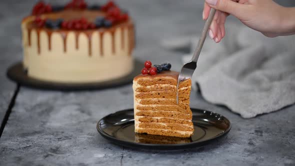 Piece of Layer Caramel Cake with Cream and Fresh Berries