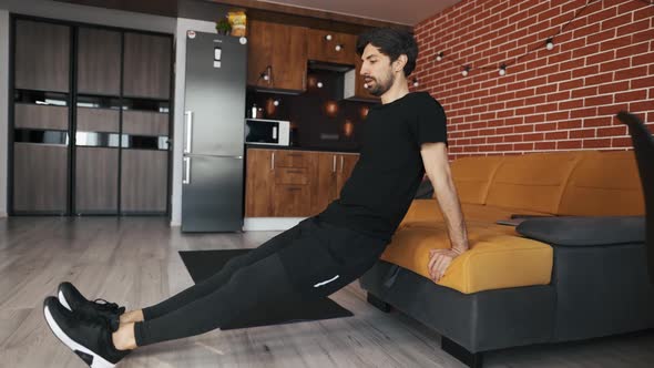 Man Athletic Doing Push Up Leaning on Sofa at Home