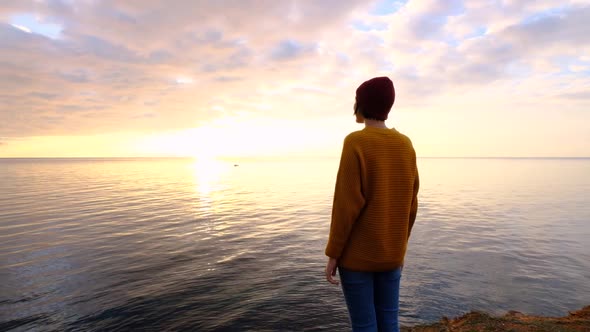 Young Beautiful Woman in Orange Sweater in Cold Weather