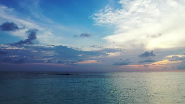 Aerial above scenery of marine tourist beach break by blue sea and white sandy background of a picni