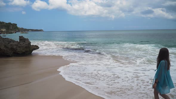 Girl Walking on the Beach. Bali, Indonesia